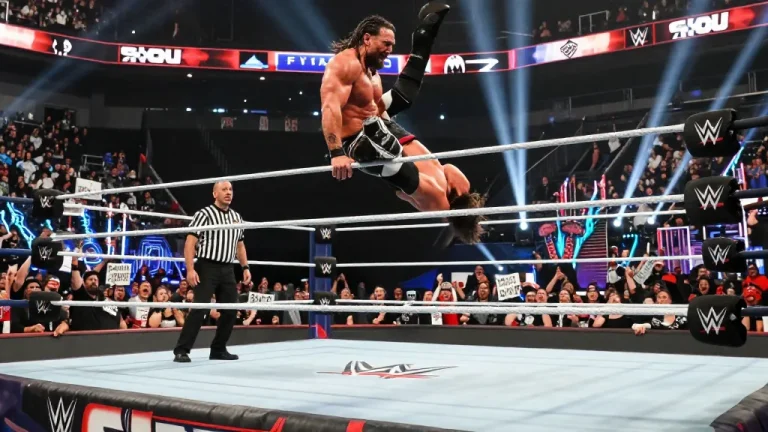 Roman Reigns title reign showcased in dynamic wrestling match with audience excitement.